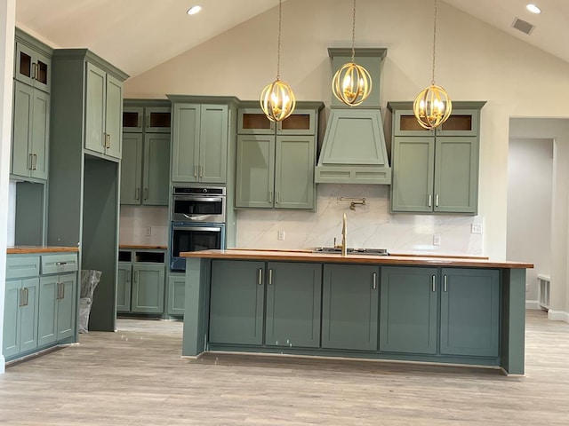 5605 E County Rd 94, Midland, TX 79706 - kitchen with green cabinets, a chandelier, premium range hood, decorative backsplash, and light wood finished floors