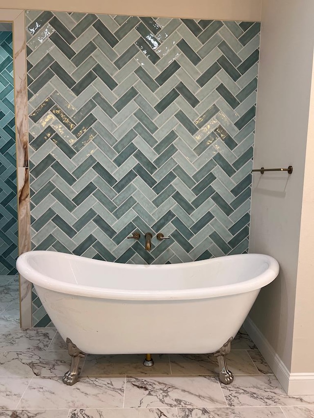 5605 E County Rd 94, Midland, TX 79706 - full bathroom with marble finish flooring, a freestanding bath, and baseboards