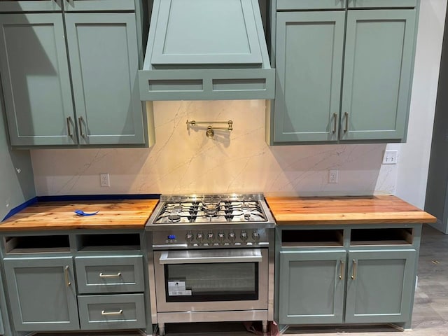 5605 E County Rd 94, Midland, TX 79706 - kitchen with butcher block counters, stainless steel stove, green cabinets, and tasteful backsplash