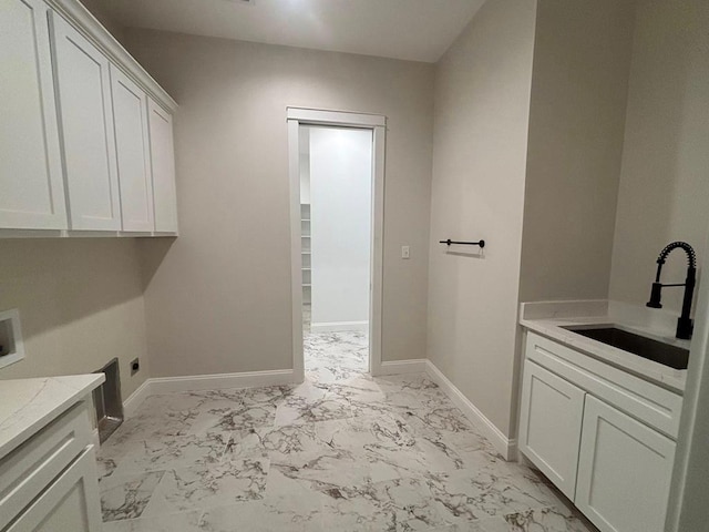 5605 E County Rd 94, Midland, TX 79706 - laundry room featuring light marble finish flooring, cabinet space, washer hookup, baseboards, and hookup for an electric dryer