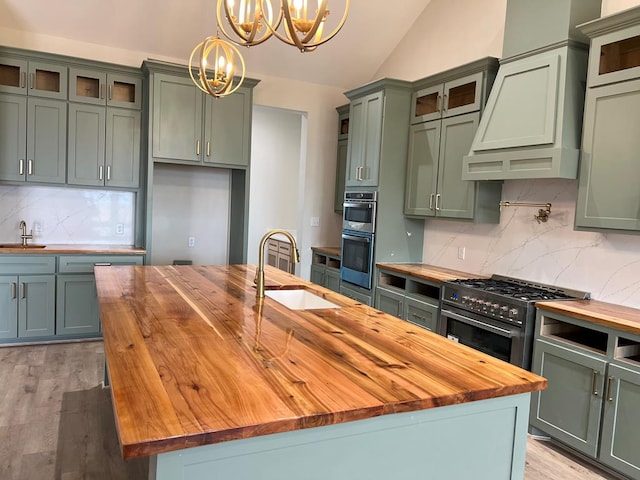 5605 E County Rd 94, Midland, TX 79706 - kitchen with wood counters, a chandelier, a sink, stainless steel appliances, and vaulted ceiling