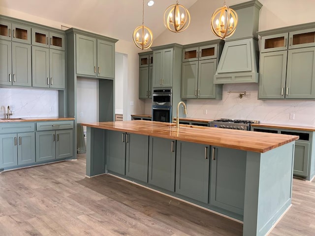 5605 E County Rd 94, Midland, TX 79706 - kitchen with wooden counters, a chandelier, green cabinetry, stainless steel appliances, and vaulted ceiling