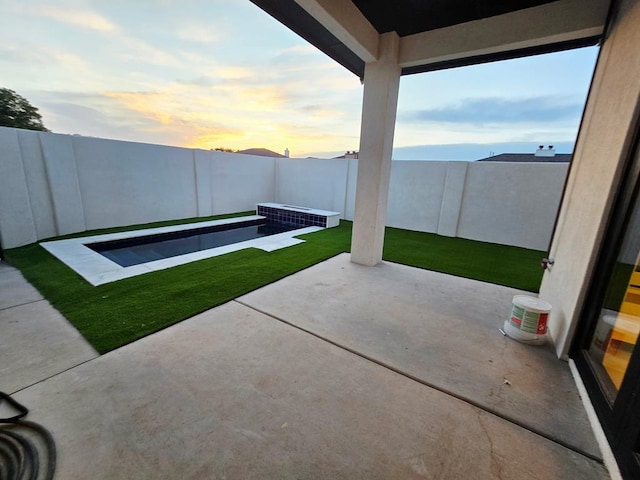 2607 Hoya Dr, Midland, TX 79707 - patio terrace at dusk featuring a patio area and a fenced backyard