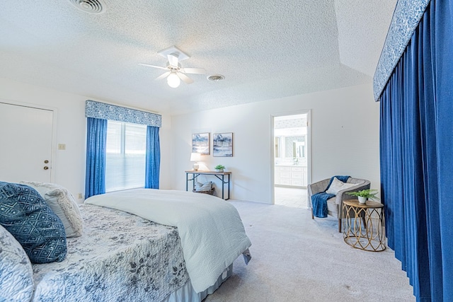 1007 Shirley Ln, Midland, TX 79705 - carpeted bedroom featuring a textured ceiling, a ceiling fan, and ensuite bath