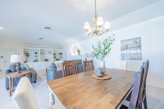 1007 Shirley Ln, Midland, TX 79705 - dining space featuring a textured ceiling, light carpet, a chandelier, and built in shelves