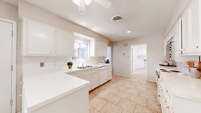 1007 Shirley Ln, Midland, TX 79705 - kitchen featuring dishwasher, white cabinets, light countertops, a peninsula, and a textured ceiling