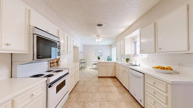 1007 Shirley Ln, Midland, TX 79705 - kitchen with white appliances, ceiling fan, a textured ceiling, light countertops, and light tile patterned floors