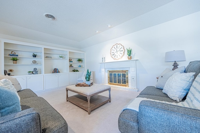 1007 Shirley Ln, Midland, TX 79705 - living room with light carpet, a fireplace, and a textured ceiling