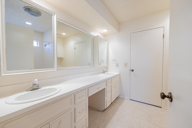 1007 Shirley Ln, Midland, TX 79705 - bathroom with double vanity and a textured ceiling