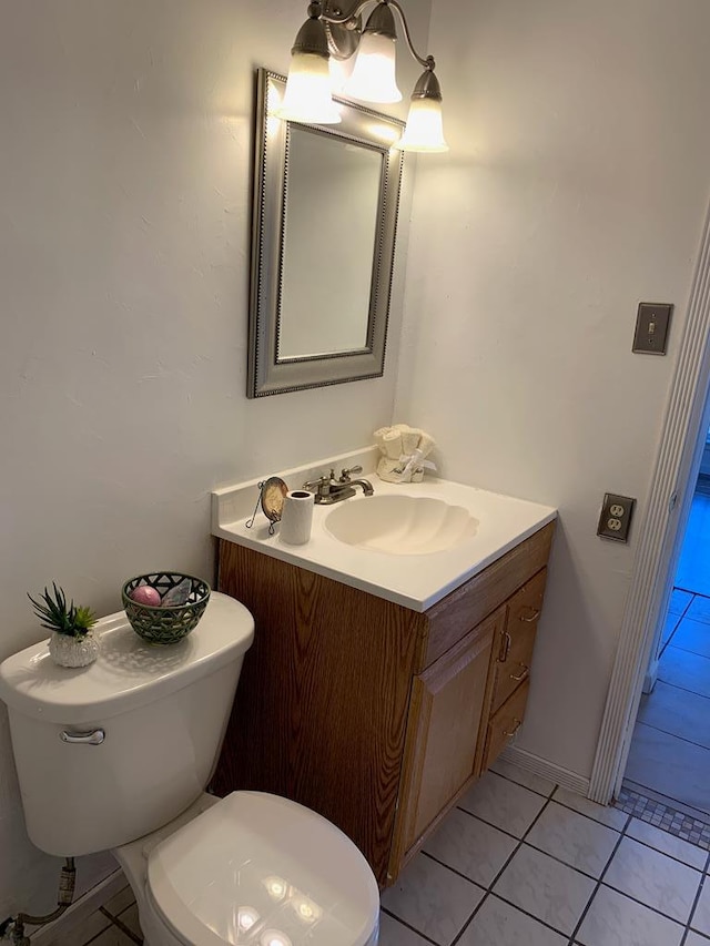 bathroom featuring toilet, tile patterned flooring, and vanity