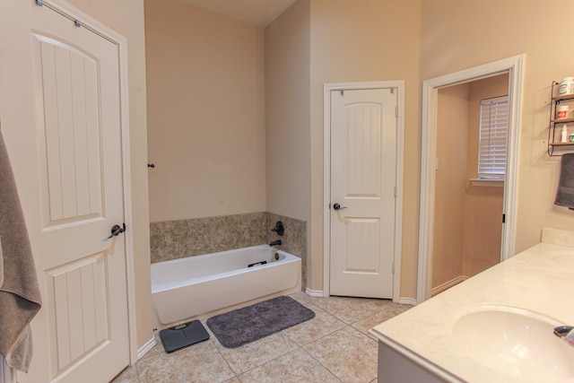 bathroom with tile patterned floors, vanity, and a bath