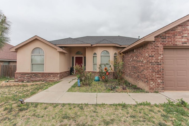 single story home featuring a front yard and a garage