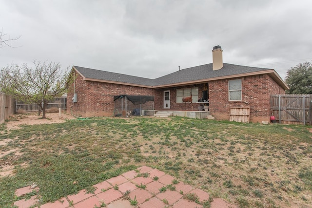 rear view of property with a yard