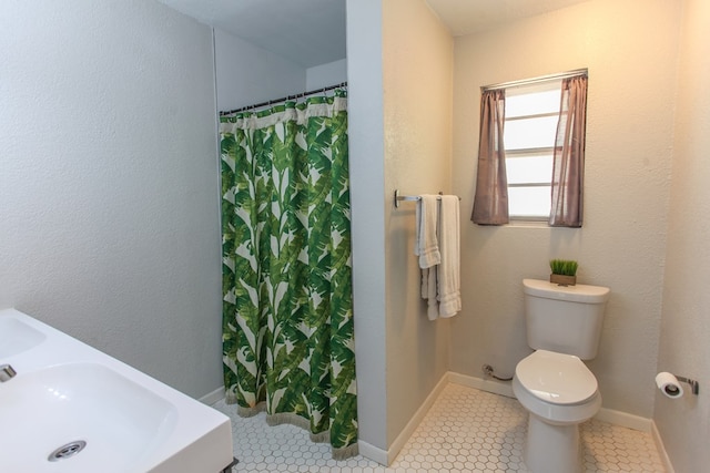 bathroom with a sink, tile patterned floors, toilet, and a shower with shower curtain