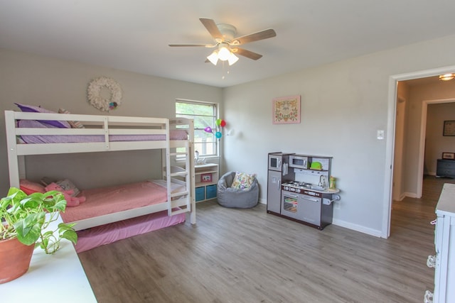bedroom featuring baseboards, a ceiling fan, and wood finished floors