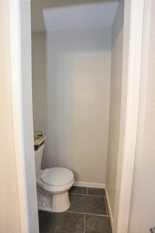 bathroom with tile patterned flooring and toilet