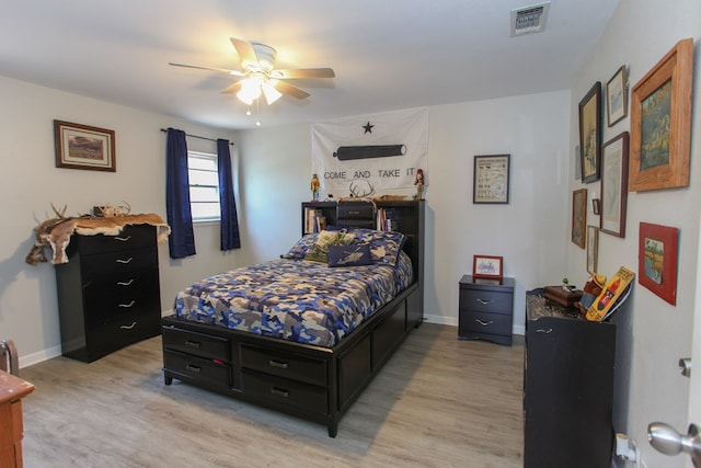 bedroom featuring baseboards, visible vents, and light wood finished floors