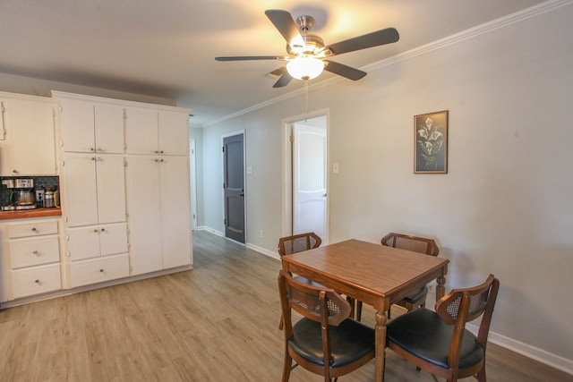 dining space with baseboards, ornamental molding, light wood-style flooring, and ceiling fan