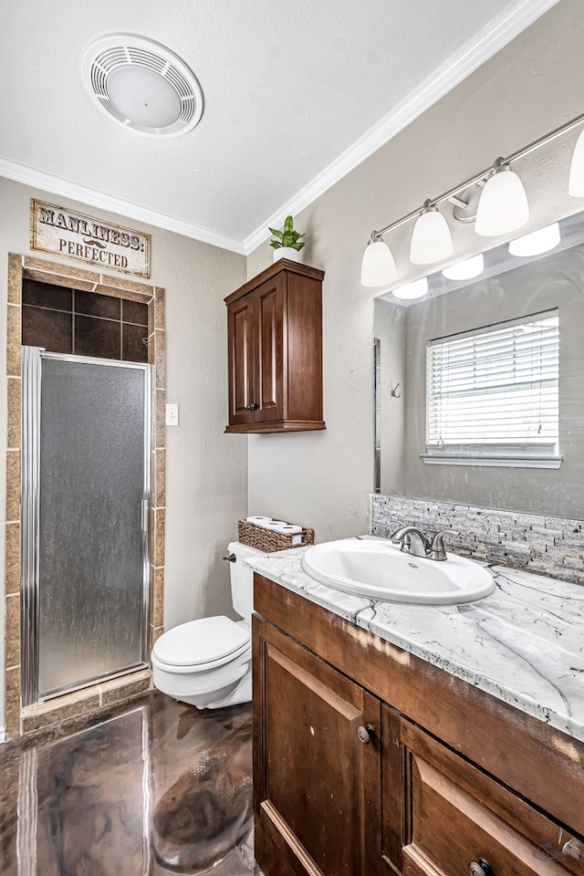 bathroom featuring a shower with door, toilet, vanity, and crown molding