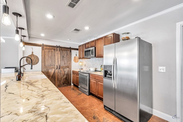 kitchen featuring light stone countertops, stainless steel appliances, sink, hanging light fixtures, and ornamental molding