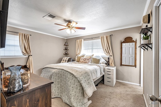 carpeted bedroom with a textured ceiling, ceiling fan, and crown molding