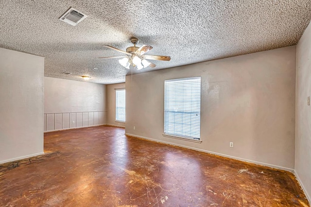 2821 Metz Dr, Midland, TX 79705 - empty room with a ceiling fan, baseboards, a textured ceiling, and finished concrete flooring