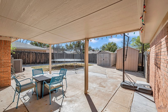 2821 Metz Dr, Midland, TX 79705 - fenced backyard featuring a trampoline, a patio, and cooling unit
