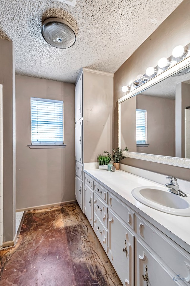2821 Metz Dr, Midland, TX 79705 - full bathroom with a textured ceiling, vanity, and baseboards