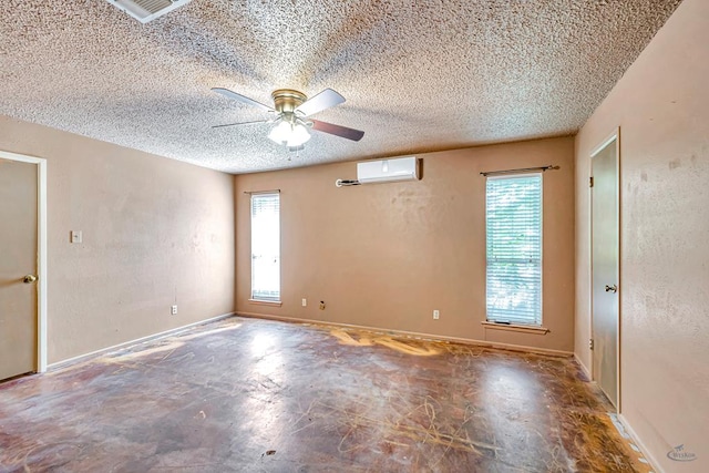 2821 Metz Dr, Midland, TX 79705 - spare room featuring a wall unit AC, a ceiling fan, a textured ceiling, and baseboards