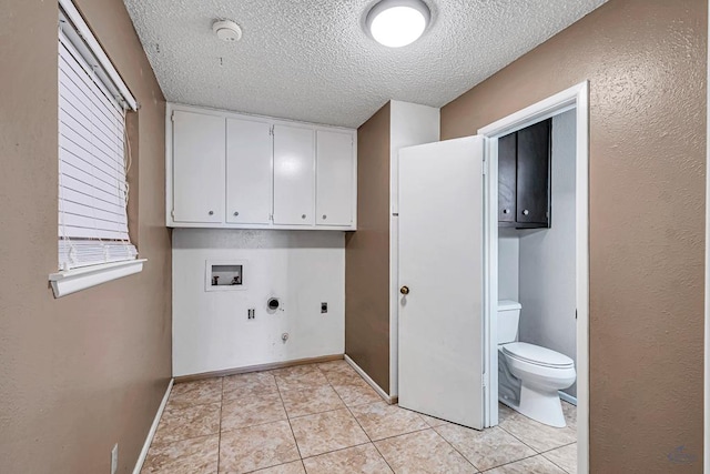2821 Metz Dr, Midland, TX 79705 - laundry area featuring gas dryer hookup, hookup for an electric dryer, cabinet space, a textured ceiling, and washer hookup