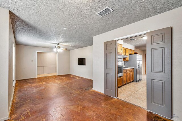 2821 Metz Dr, Midland, TX 79705 - unfurnished room featuring a ceiling fan, a textured ceiling, and baseboards