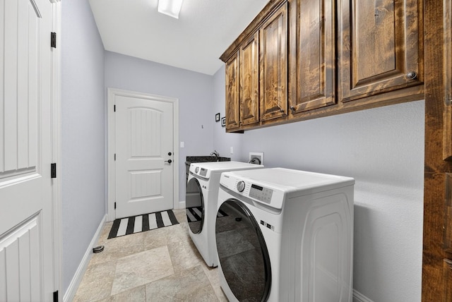 5514 Casa Grande Trl, Midland, TX 79707 - laundry room with cabinet space, washing machine and dryer, baseboards, and stone finish floors
