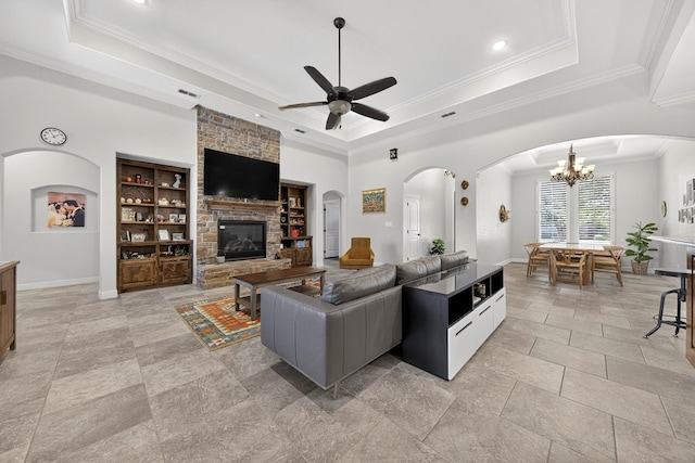 5514 Casa Grande Trl, Midland, TX 79707 - living area featuring a tray ceiling, ceiling fan, a stone fireplace, ornamental molding, and built in shelves