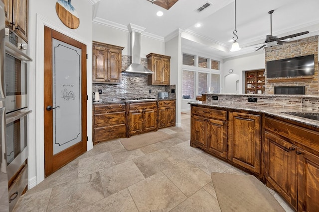 5514 Casa Grande Trl, Midland, TX 79707 - kitchen featuring wall chimney range hood, crown molding, tasteful backsplash, gas cooktop, and a ceiling fan