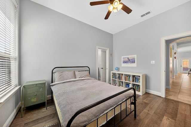 5514 Casa Grande Trl, Midland, TX 79707 - bedroom featuring baseboards, wood finished floors, arched walkways, vaulted ceiling, and ceiling fan