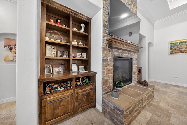 5514 Casa Grande Trl, Midland, TX 79707 - living room featuring ornamental molding, arched walkways, baseboards, a stone fireplace, and light stone finish floors