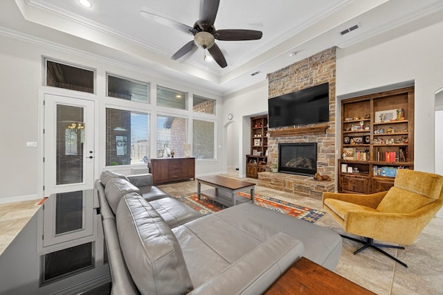 5514 Casa Grande Trl, Midland, TX 79707 - living room featuring crown molding, a tray ceiling, ceiling fan, a stone fireplace, and recessed lighting