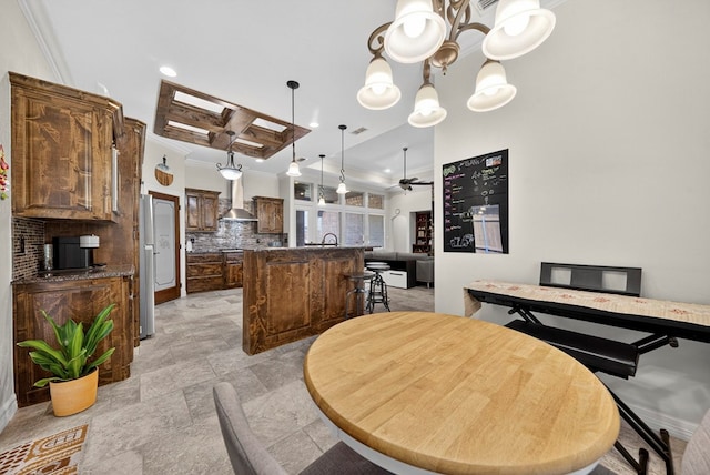 5514 Casa Grande Trl, Midland, TX 79707 - dining area featuring ornamental molding, a ceiling fan, light stone finish floors, recessed lighting, and a chandelier