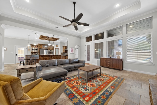 5514 Casa Grande Trl, Midland, TX 79707 - living area featuring a tray ceiling, crown molding, ceiling fan, baseboards, and recessed lighting