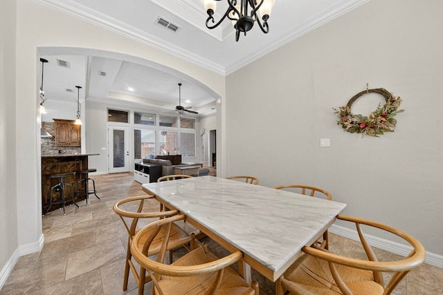 5514 Casa Grande Trl, Midland, TX 79707 - dining area with arched walkways, ceiling fan, baseboards, crown molding, and a chandelier