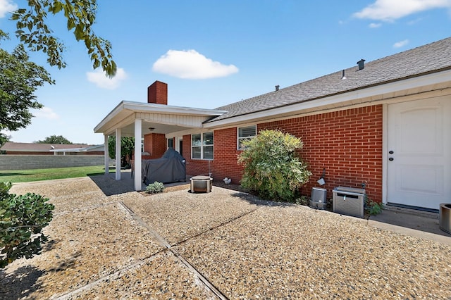 2802 Cimmaron Ave, Midland, TX 79705 - back of property featuring brick siding, a chimney, and a patio area
