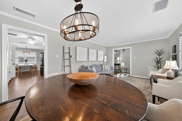 2802 Cimmaron Ave, Midland, TX 79705 - dining area featuring a chandelier, wood finished floors, and ornamental molding