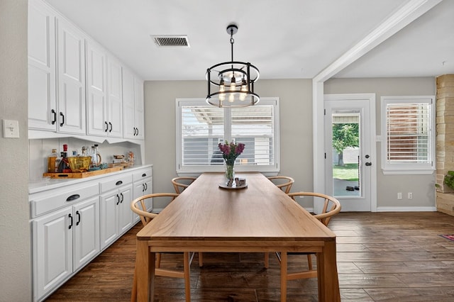 2802 Cimmaron Ave, Midland, TX 79705 - dining space with dark wood-style floors, healthy amount of natural light, and a chandelier