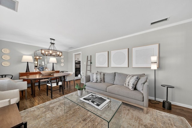 2802 Cimmaron Ave, Midland, TX 79705 - living area featuring crown molding, wood finished floors, and a chandelier
