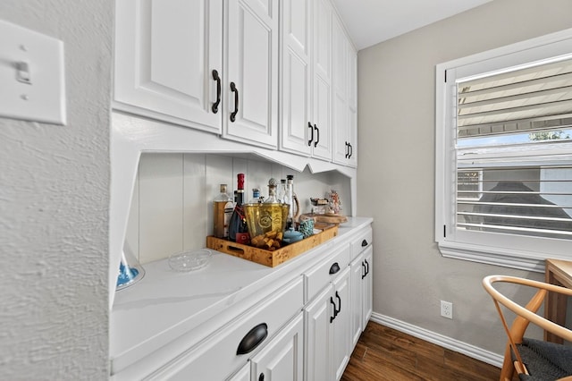 2802 Cimmaron Ave, Midland, TX 79705 - bar with dark wood-style flooring and baseboards