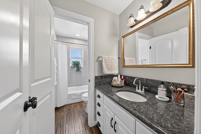 2802 Cimmaron Ave, Midland, TX 79705 - full bathroom featuring vanity, wood finished floors, and shower / bath combo
