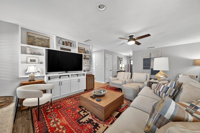 2802 Cimmaron Ave, Midland, TX 79705 - living room featuring ceiling fan, light wood-style floors, and built in shelves