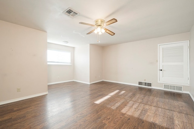 empty room with a ceiling fan, visible vents, and wood finished floors