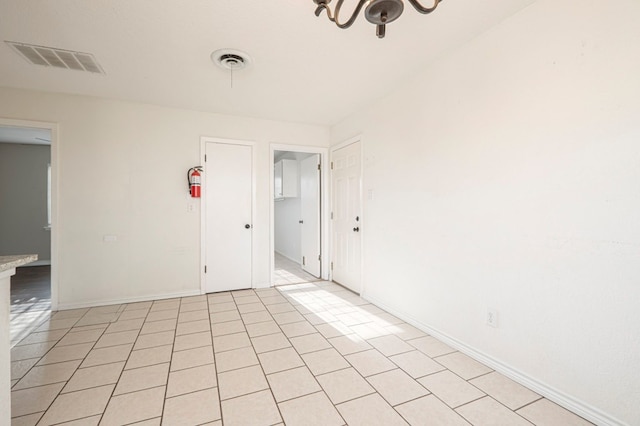 unfurnished room with visible vents and baseboards