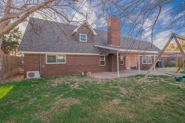 back of house featuring a patio area, a fenced backyard, brick siding, and a yard